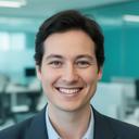 Taslim Felthouse smiling in a modern office